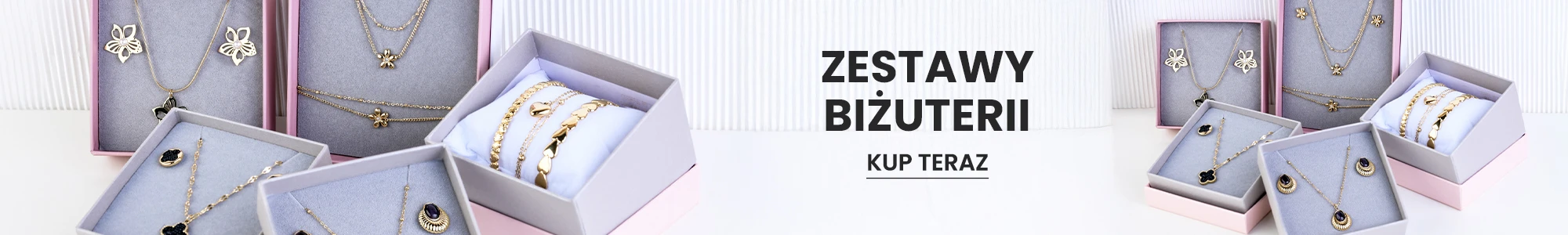 Eleganckie zestawy biżuterii w pudełkach prezentowych, naszyjniki, bransoletki i kolczyki.