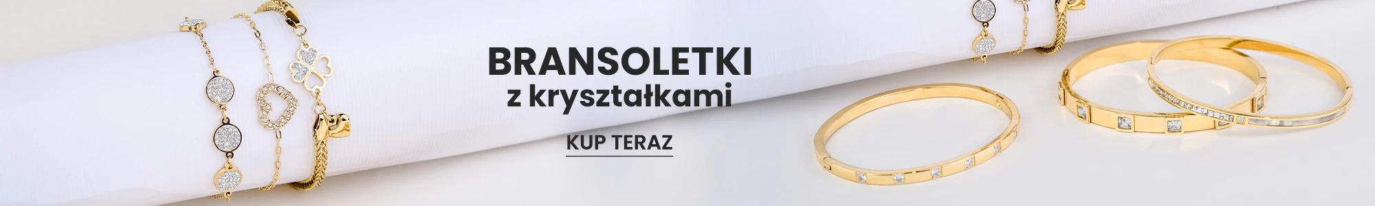 Złote bransoletki z kryształkami na białym tle, biżuteria damska