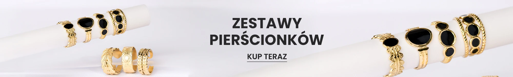 Zestaw złotych pierścionków z czarnymi oczkami i motywem liści na białym tle – kolekcja biżuterii modowej